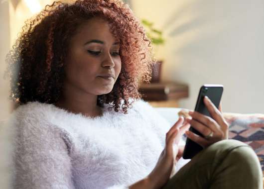 Photo of a person looking at their smartphone