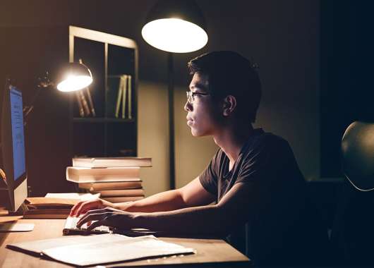 Man sitting at desk working on computer