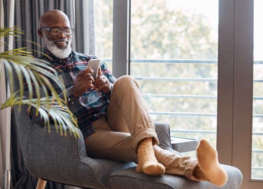 older man looking at phone