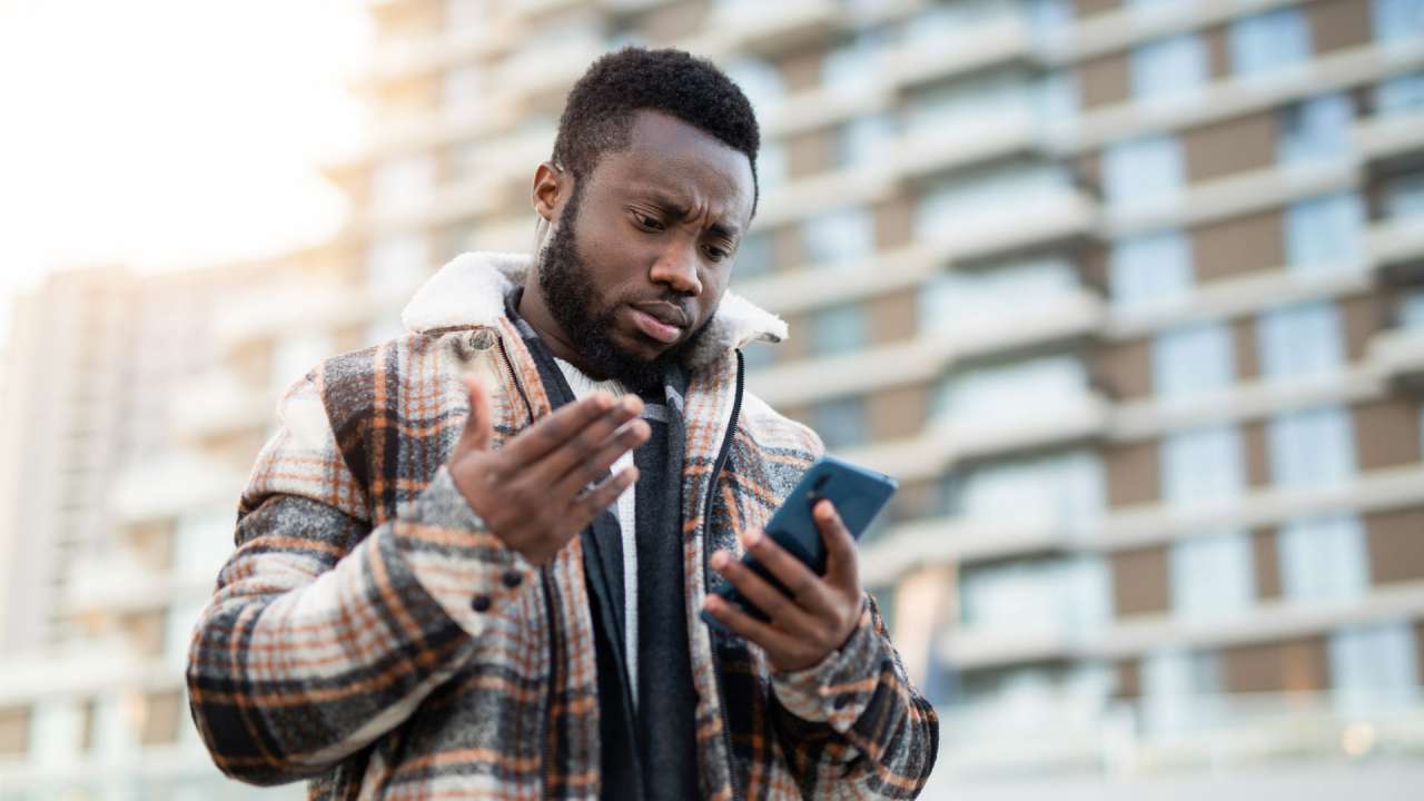 A man looking down at his phone.