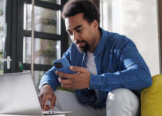 Man researching 888 area code number on laptop.