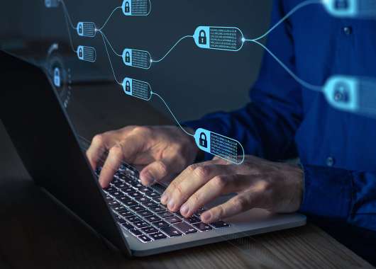 Image of hands typing on a laptop leyboard