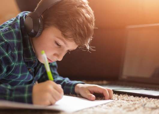 Young-boy-studying-with-tablet-at-home