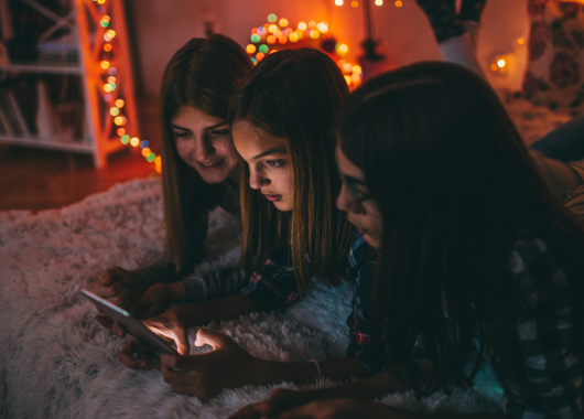 teen-girls-in-room-on-phone-tablet-online-slang