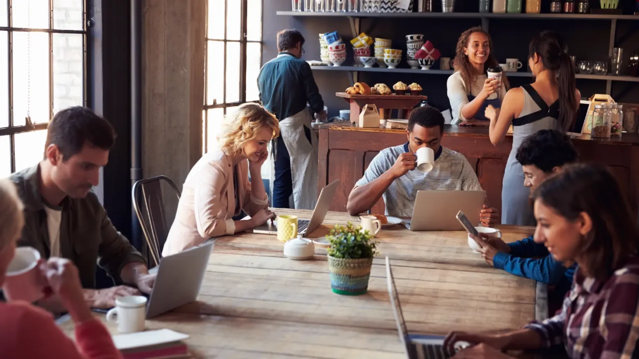 A busy cafe with many people connecting to Wi-Fi on laptops