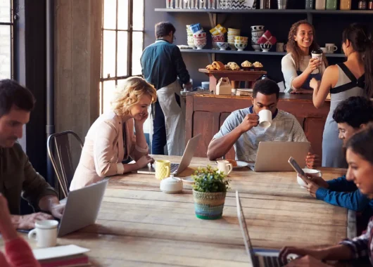 A busy cafe with many people connecting to Wi-Fi on laptops